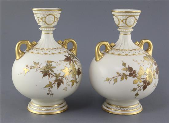 A pair of Royal Worcester ivory ground twin handled vases, date code for 1887, height 23cm